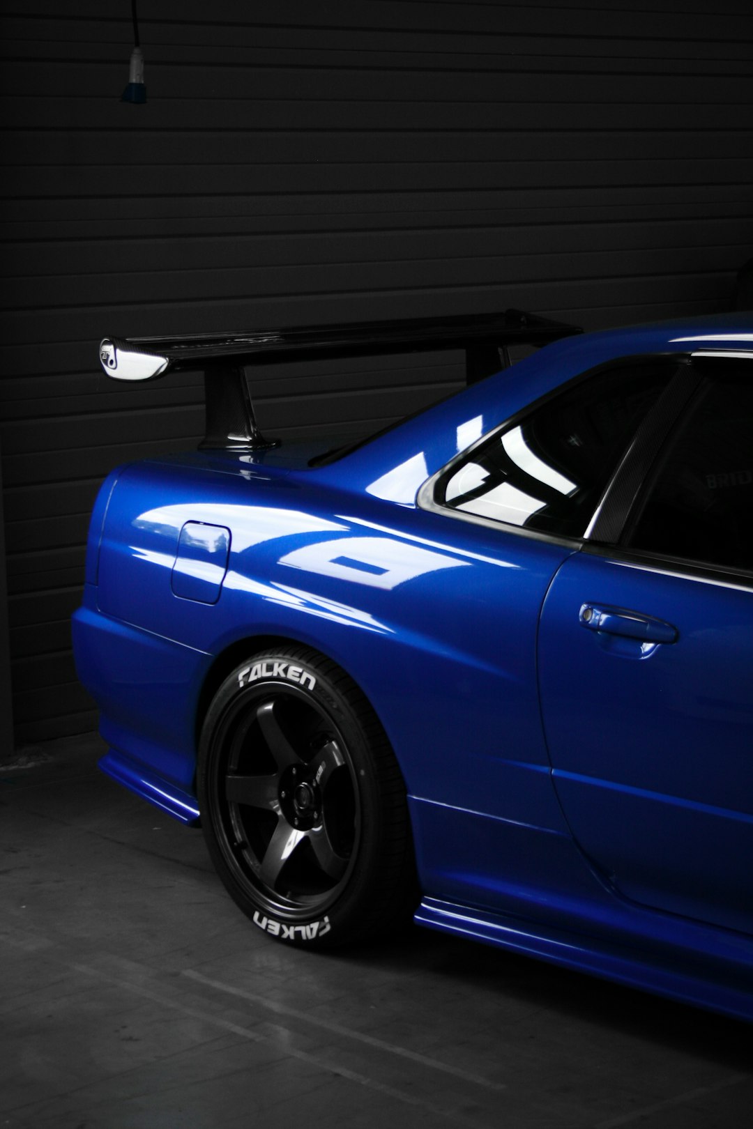 a blue sports car parked in a garage