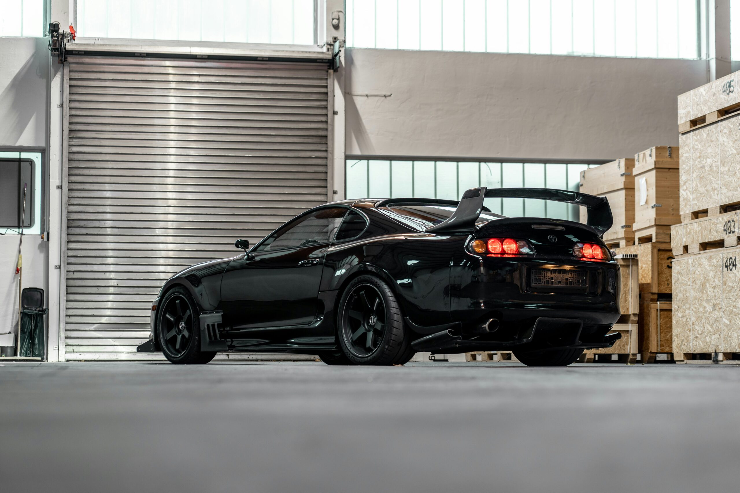 Black MK4 Supra parked in garage  By Alexandru Ivanov