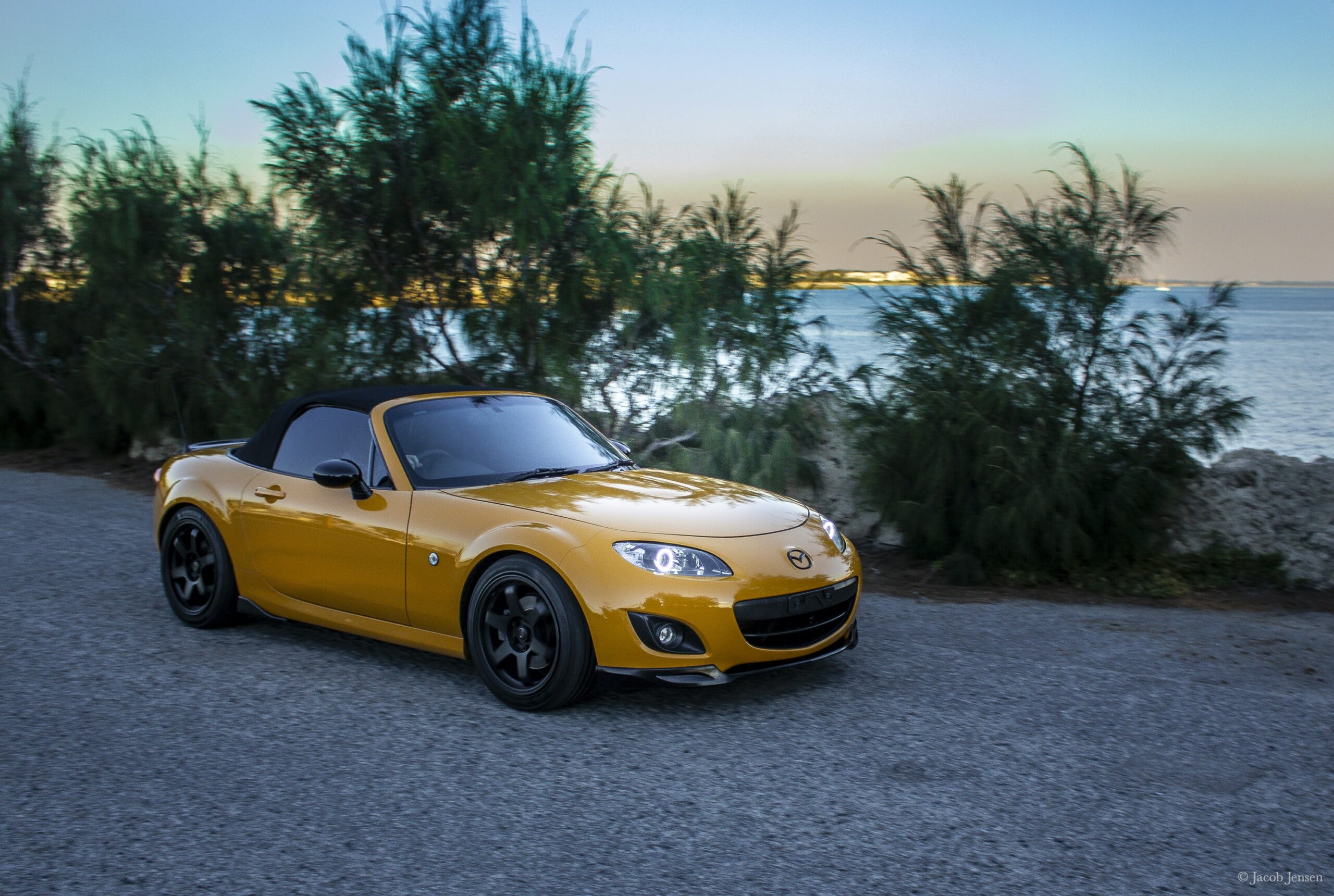Yellow Mx5 NCon road during daytime  By Jacob Jensen