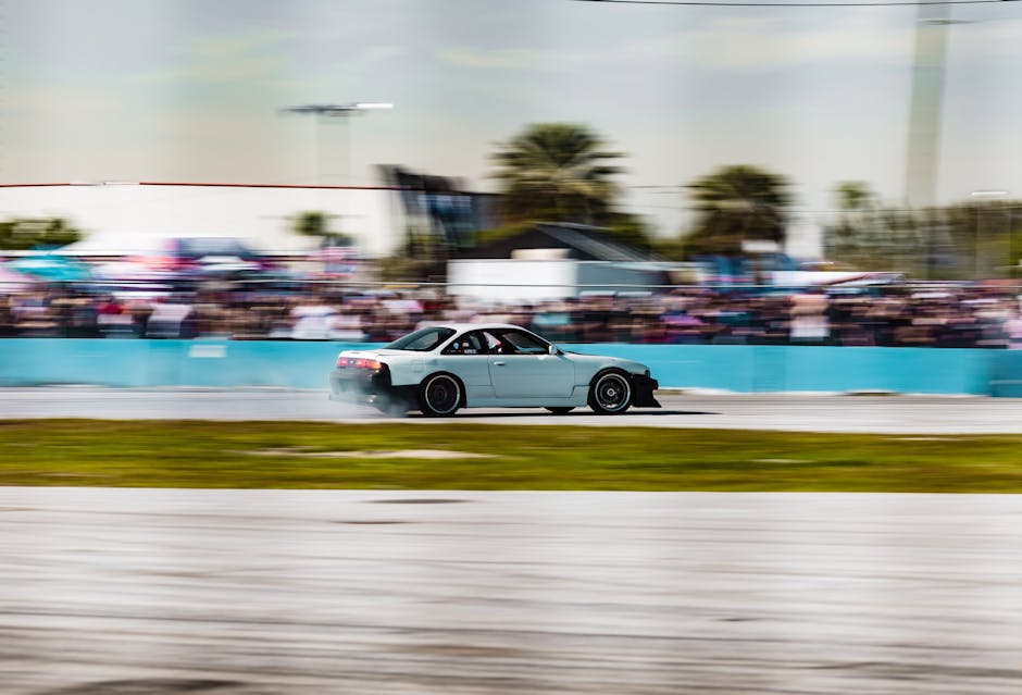 A high-speed drift car in action on a racing circuit, blurring the background with speed and motion.